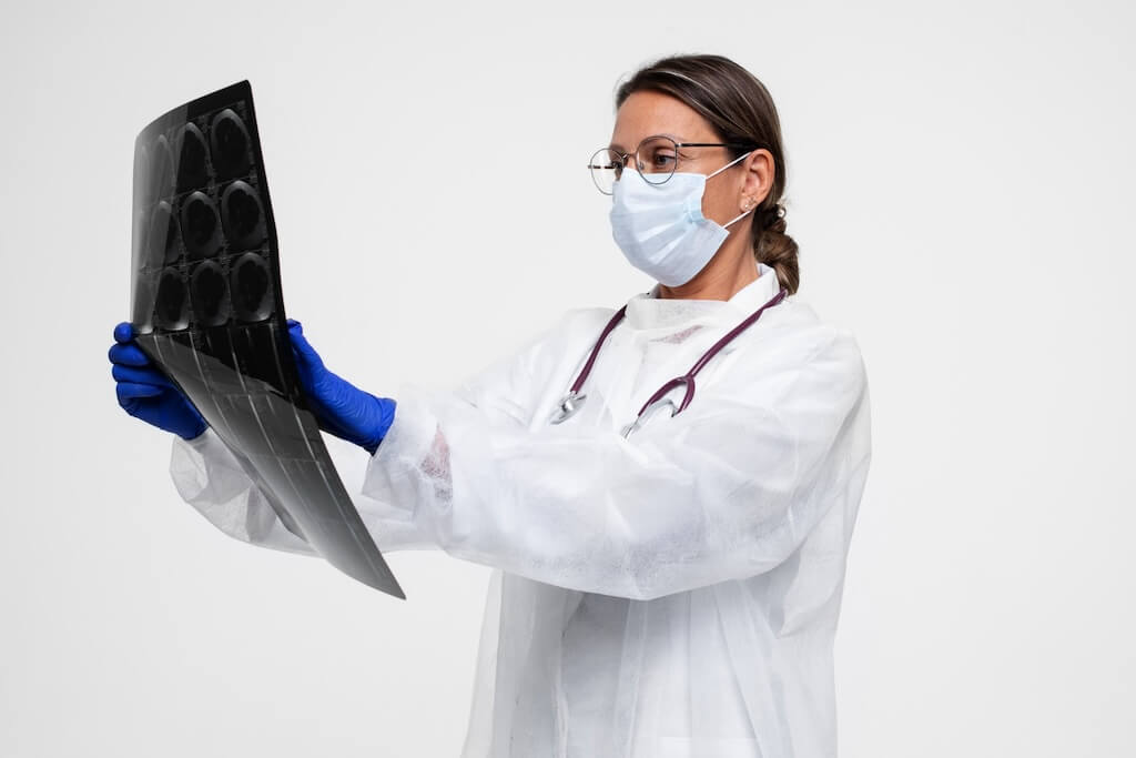 portrait-woman-wearing-medical-gown-holding-x-ray